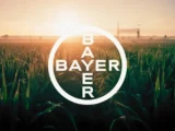 Bayer Logo mit Ruveon Schriftzug und US-Flagge im Hintergrund – Symbol für die Ausgliederung des Glyphosat-Geschäfts